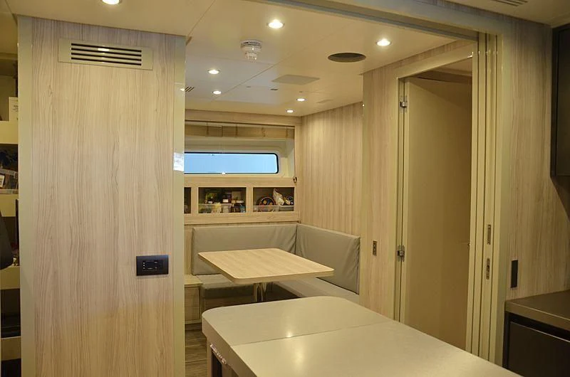a room with a table and a door aboard THE PALM Yacht for Sale