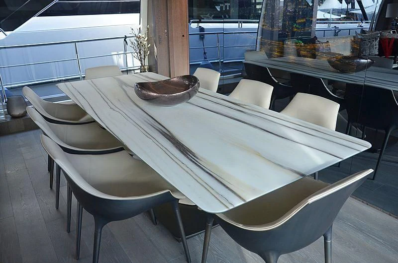 a table with chairs around it aboard THE PALM Yacht for Sale