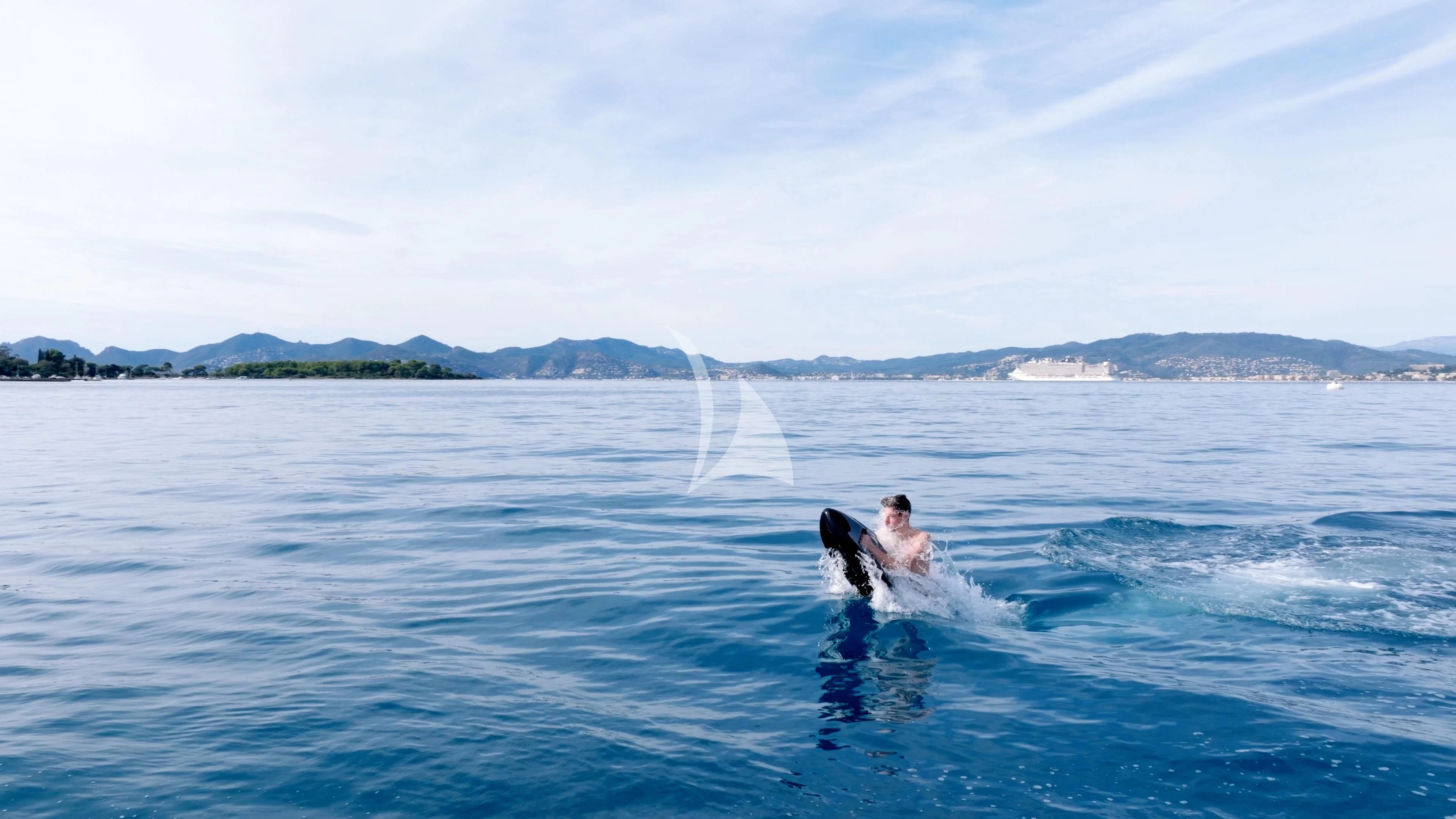 a person and a dog surfing in the sea aboard THE PALM Yacht for Sale