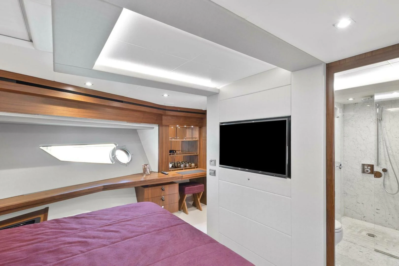 a bedroom with a bed and a television aboard ALEXA Yacht for Sale