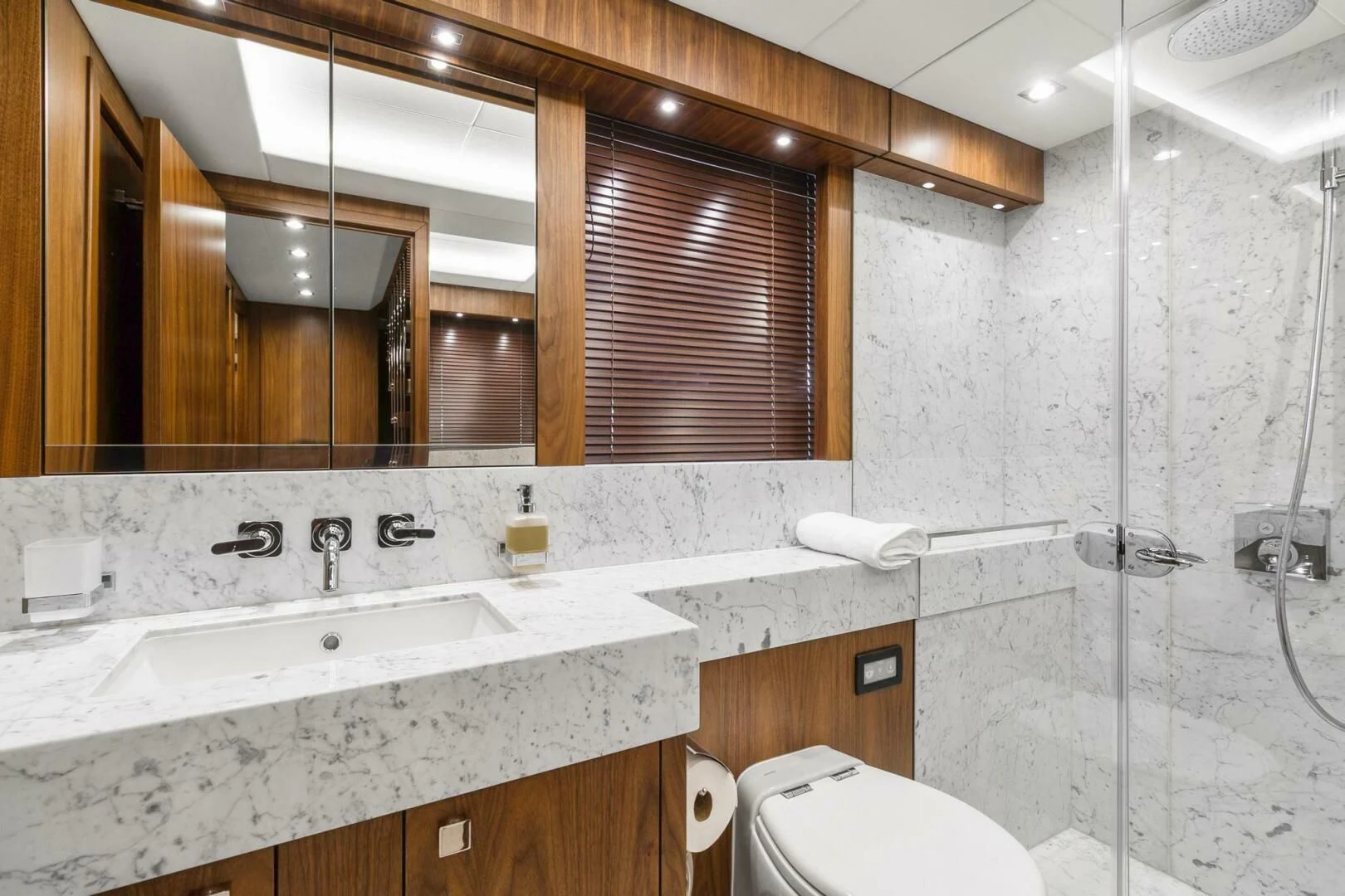 a bathroom with a large mirror aboard ALEXA Yacht for Sale