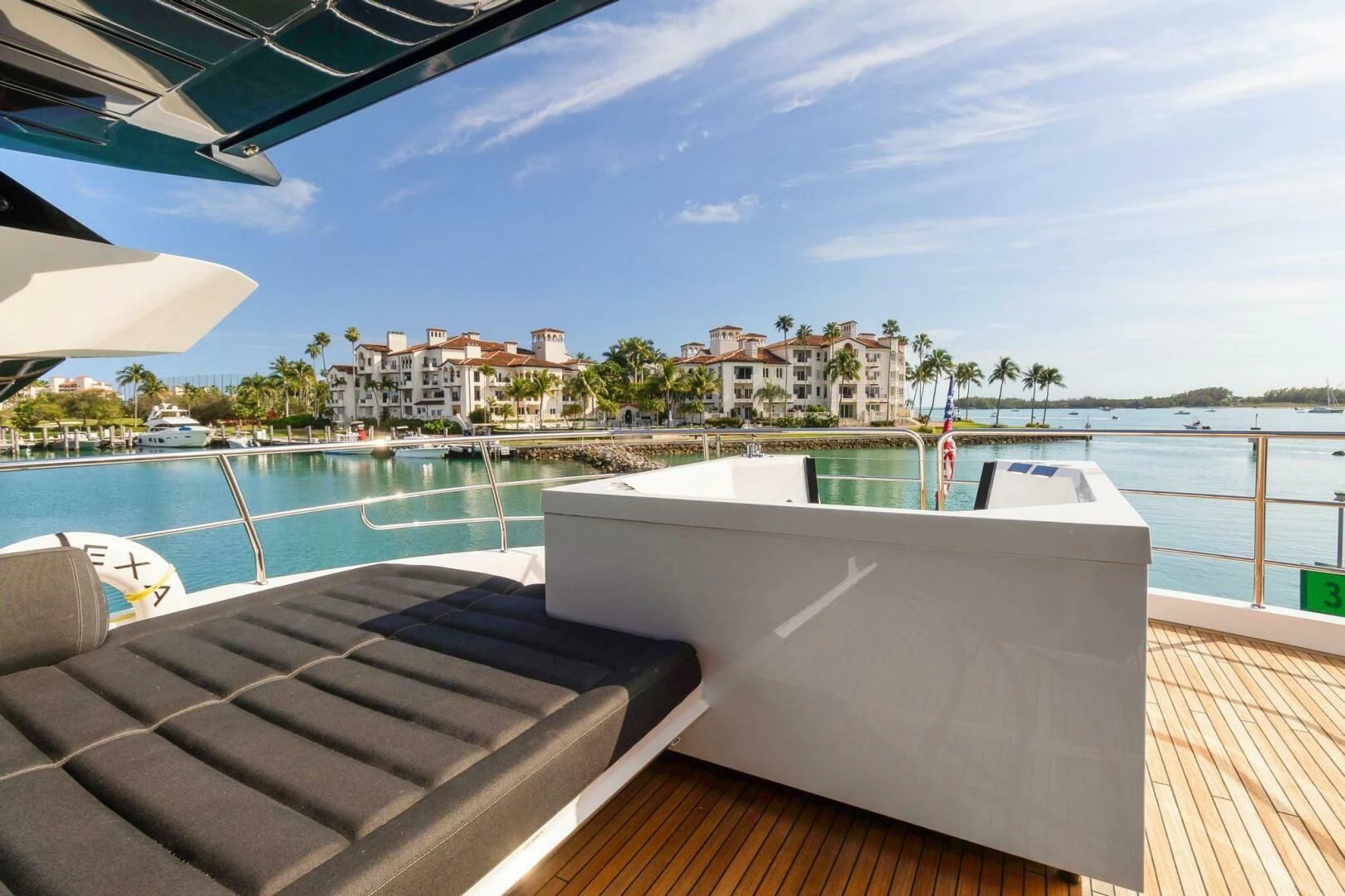 a deck with a pool and buildings in the background aboard ALEXA Yacht for Sale