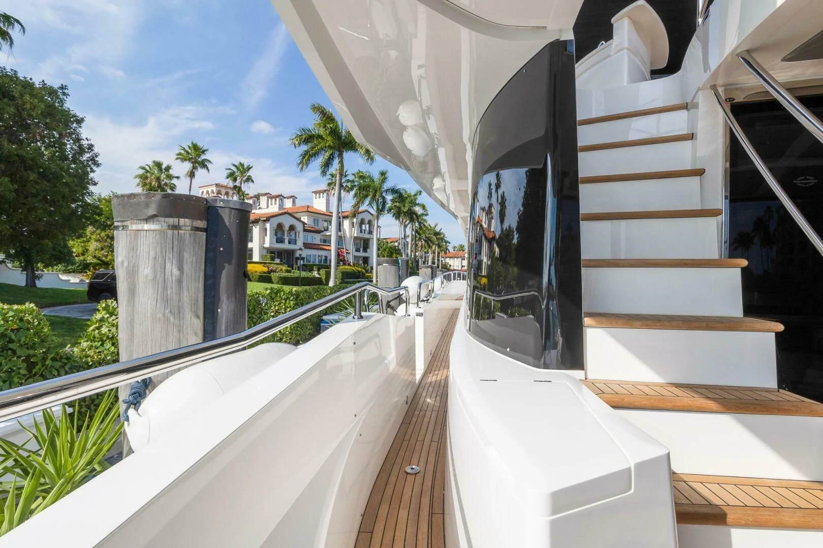 a balcony with a railing and a railing with a building and trees aboard ALEXA Yacht for Sale