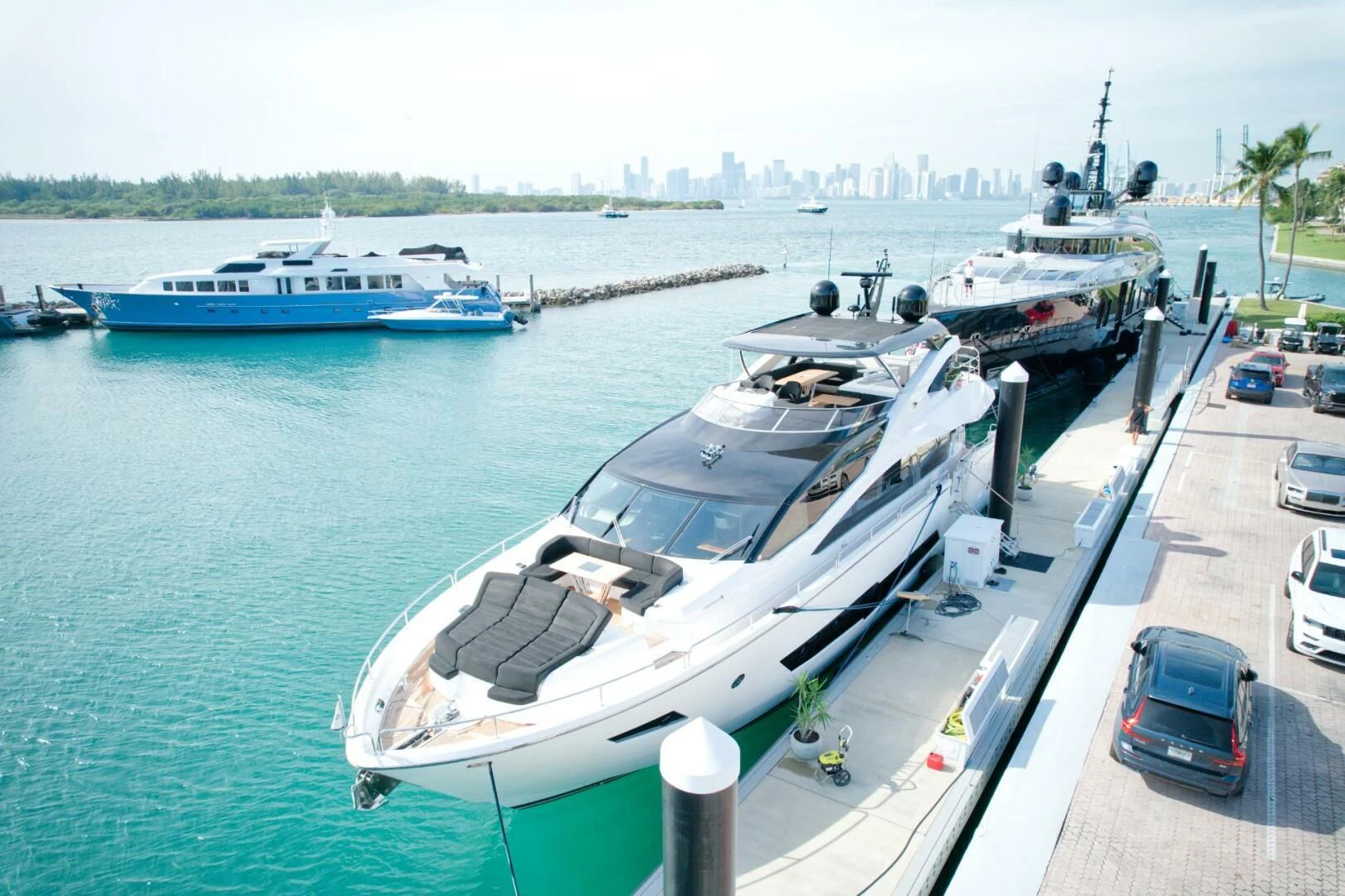 a car parked on a dock next to a boat aboard ALEXA Yacht for Sale
