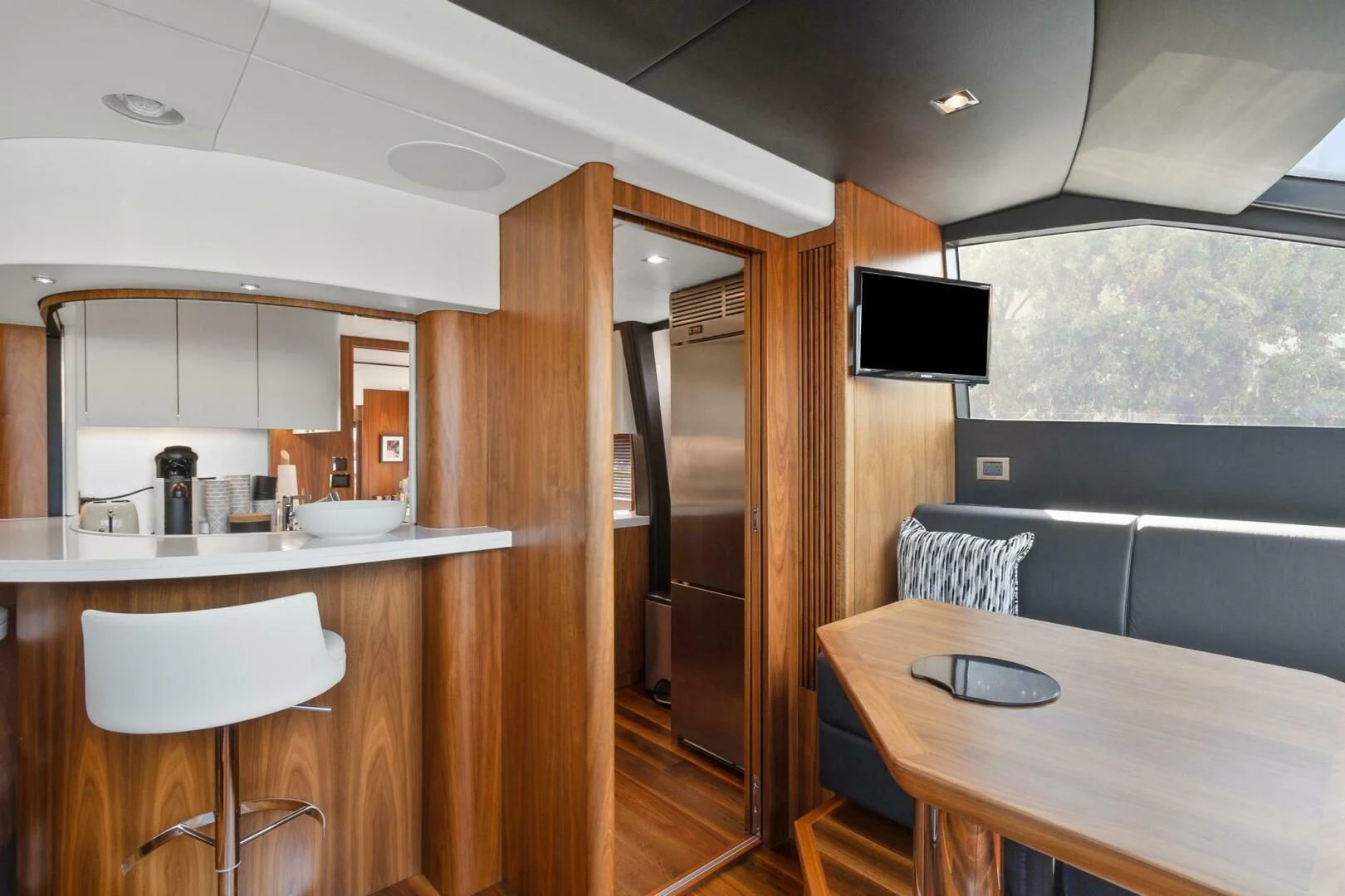 a kitchen with a table and chairs aboard ALEXA Yacht for Sale