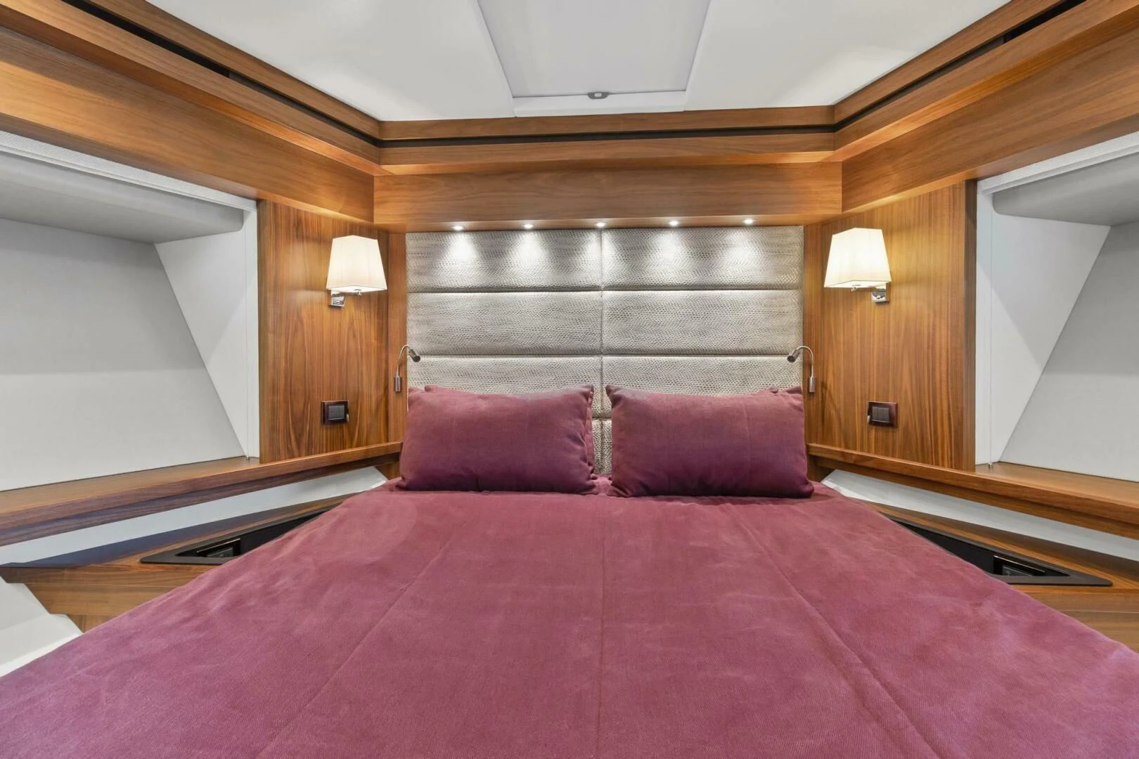 a bed with a purple comforter aboard ALEXA Yacht for Sale