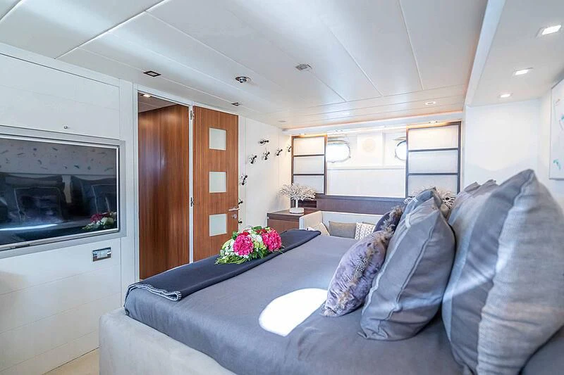 a living room with a couch and a fireplace aboard LEX Yacht for Sale
