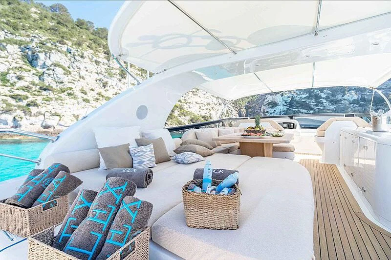 a room with a bed and a table and chairs aboard LEX Yacht for Sale