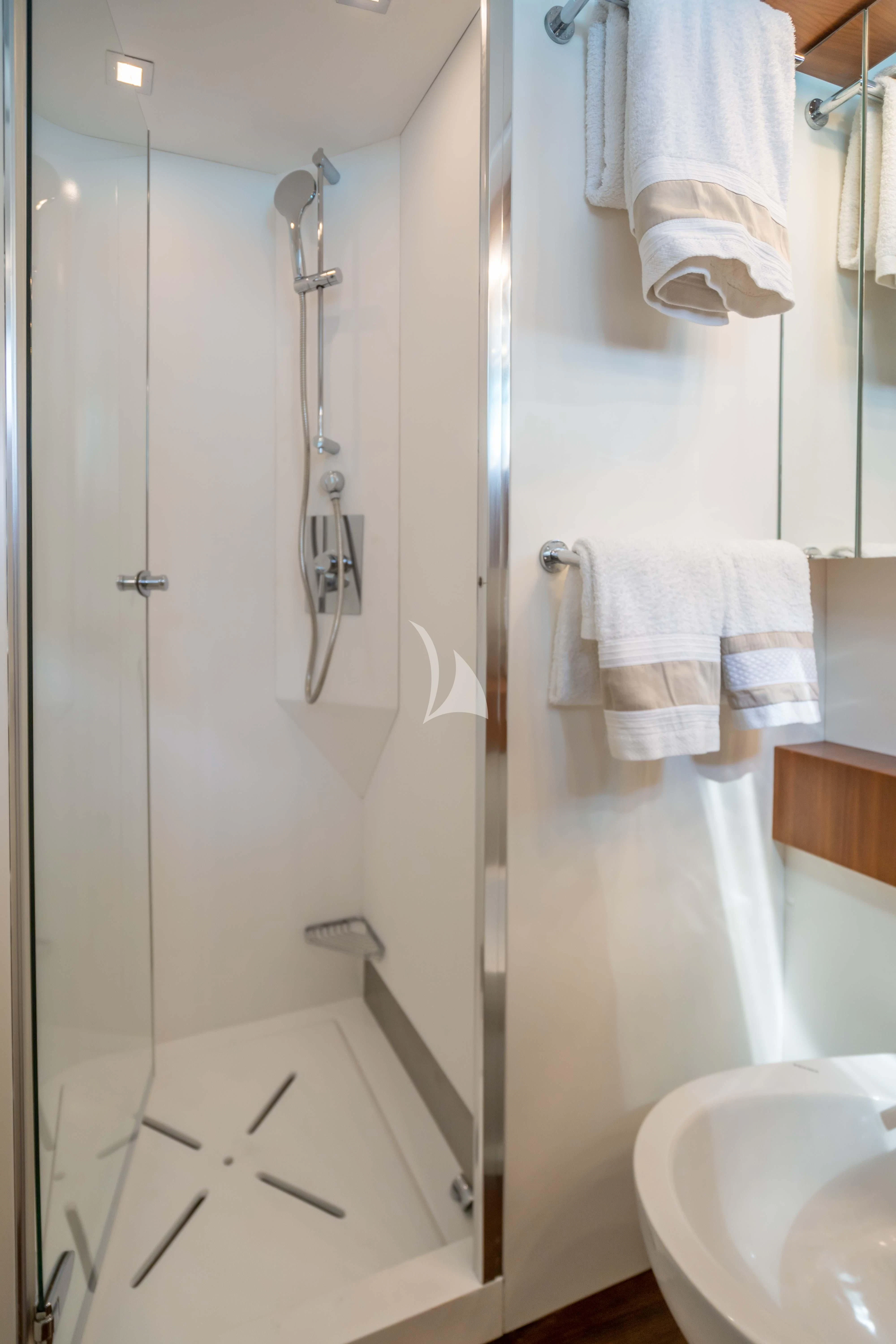 a bathroom with a shower and sink aboard LEX Yacht for Sale