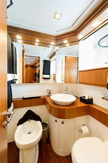 a bathroom with a toilet and a sink aboard LEX Yacht for Sale