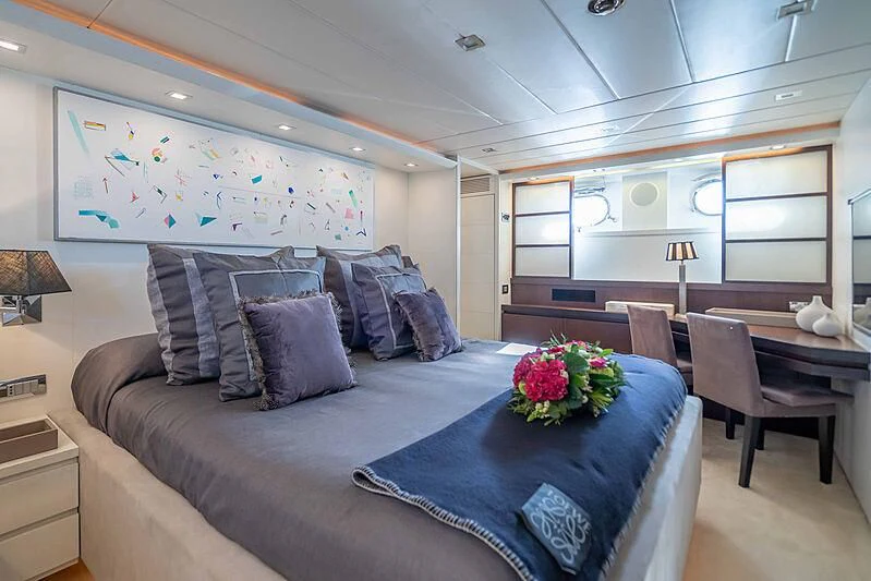 a living room with a couch and a table aboard LEX Yacht for Sale