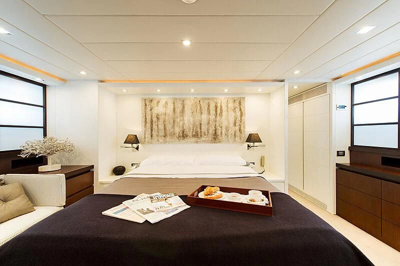a large bedroom with a bed aboard LEX Yacht for Sale