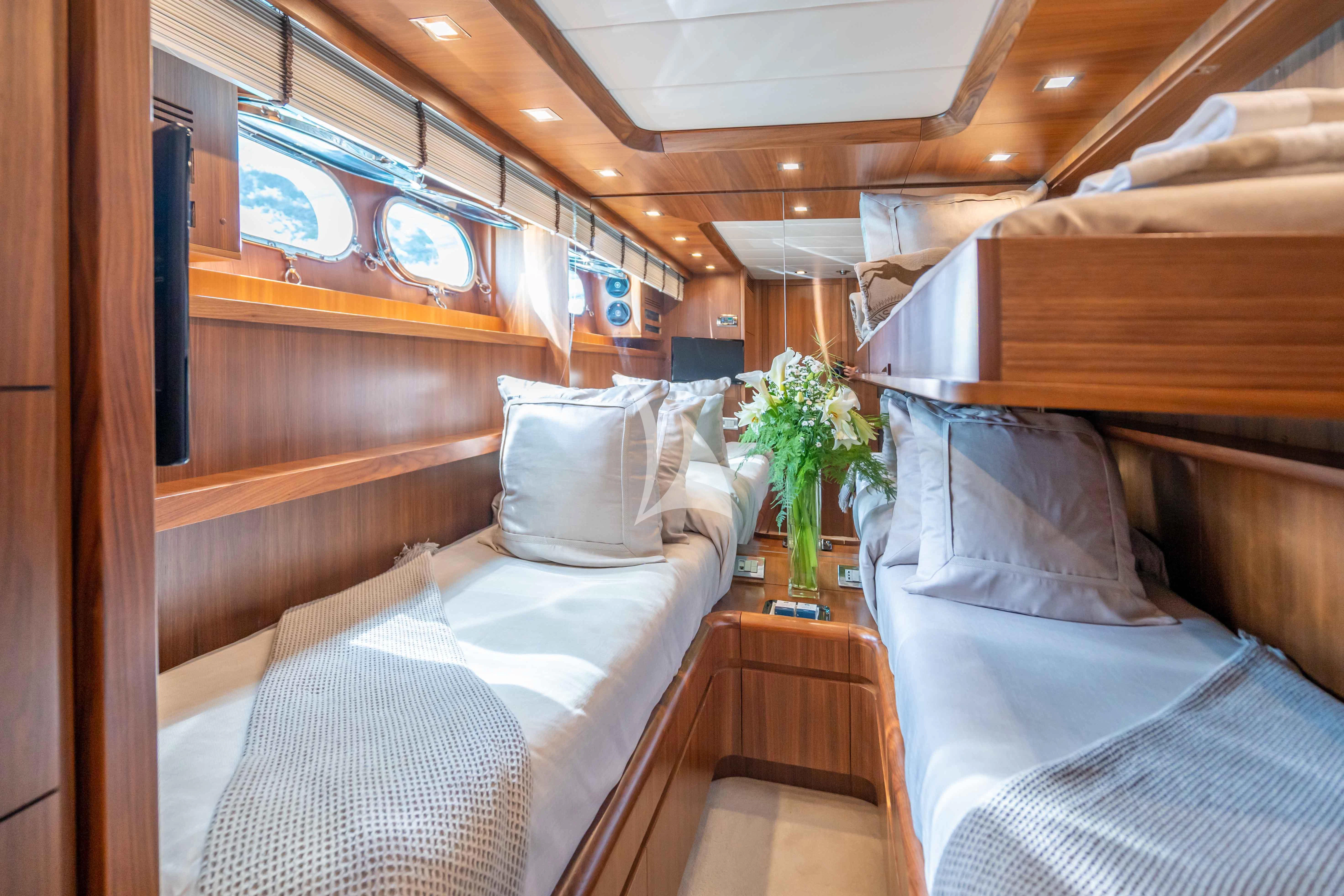 a room with a bed and a chair aboard LEX Yacht for Sale