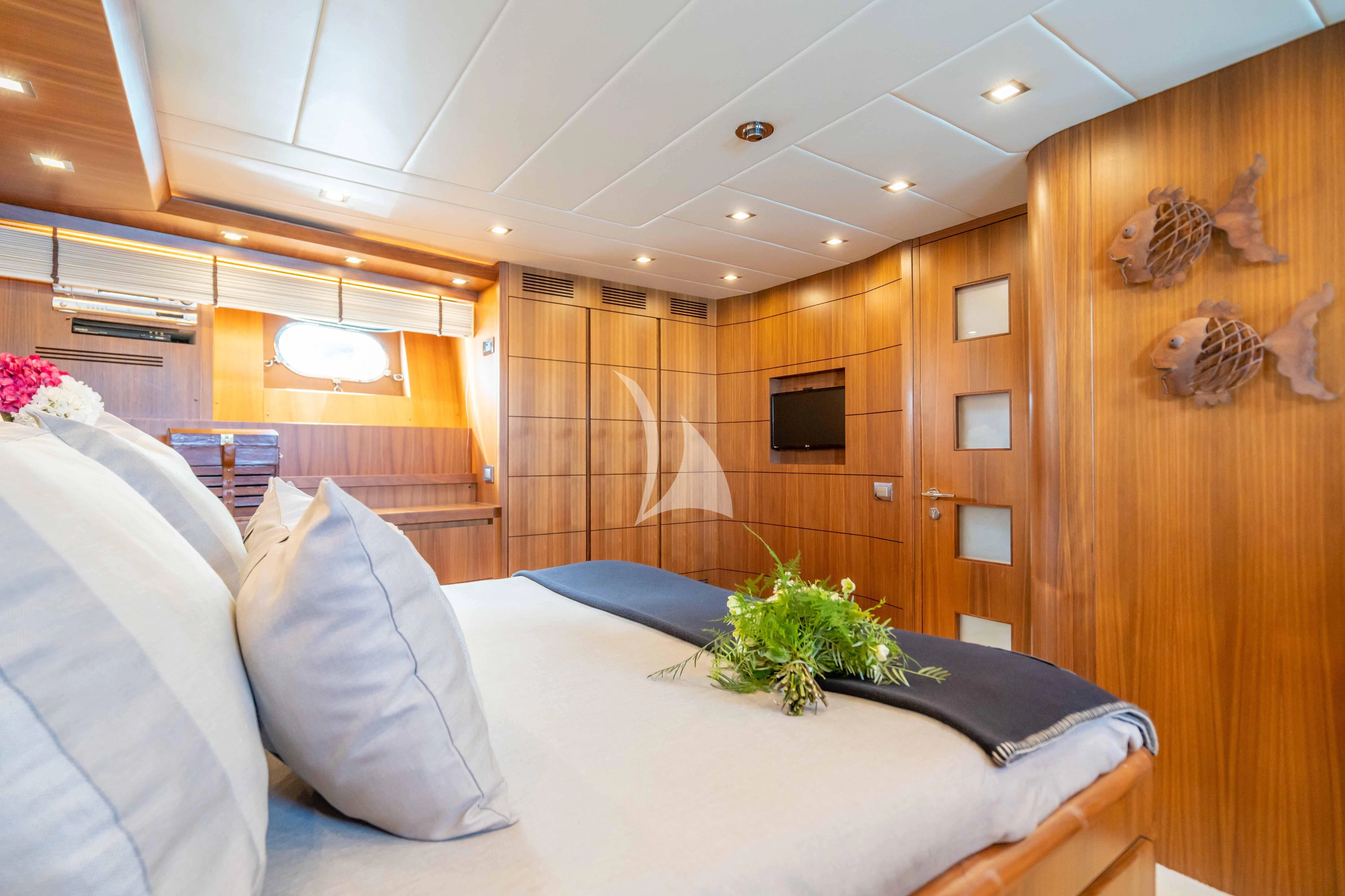 a room with a bed and a television aboard LEX Yacht for Sale