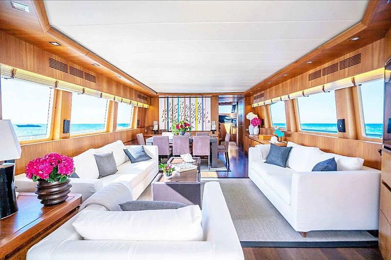 a living room with a couch and a table aboard LEX Yacht for Sale