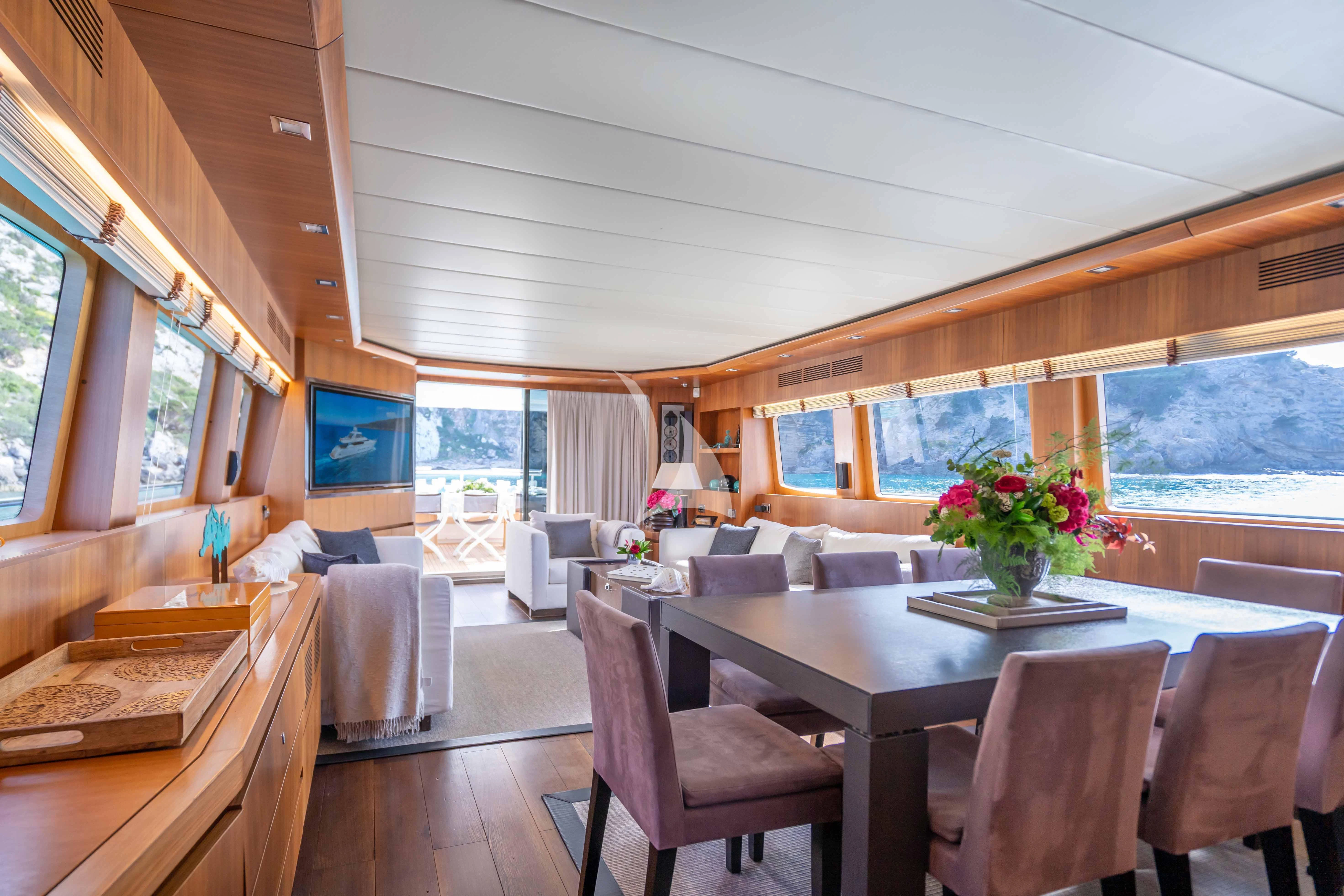 a dining room with a large window aboard LEX Yacht for Sale