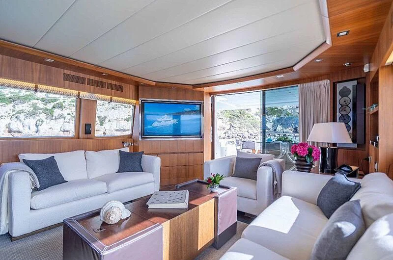 a living room with a large screen aboard LEX Yacht for Sale