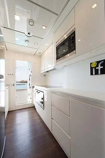 a kitchen with white cabinets aboard LEX Yacht for Sale