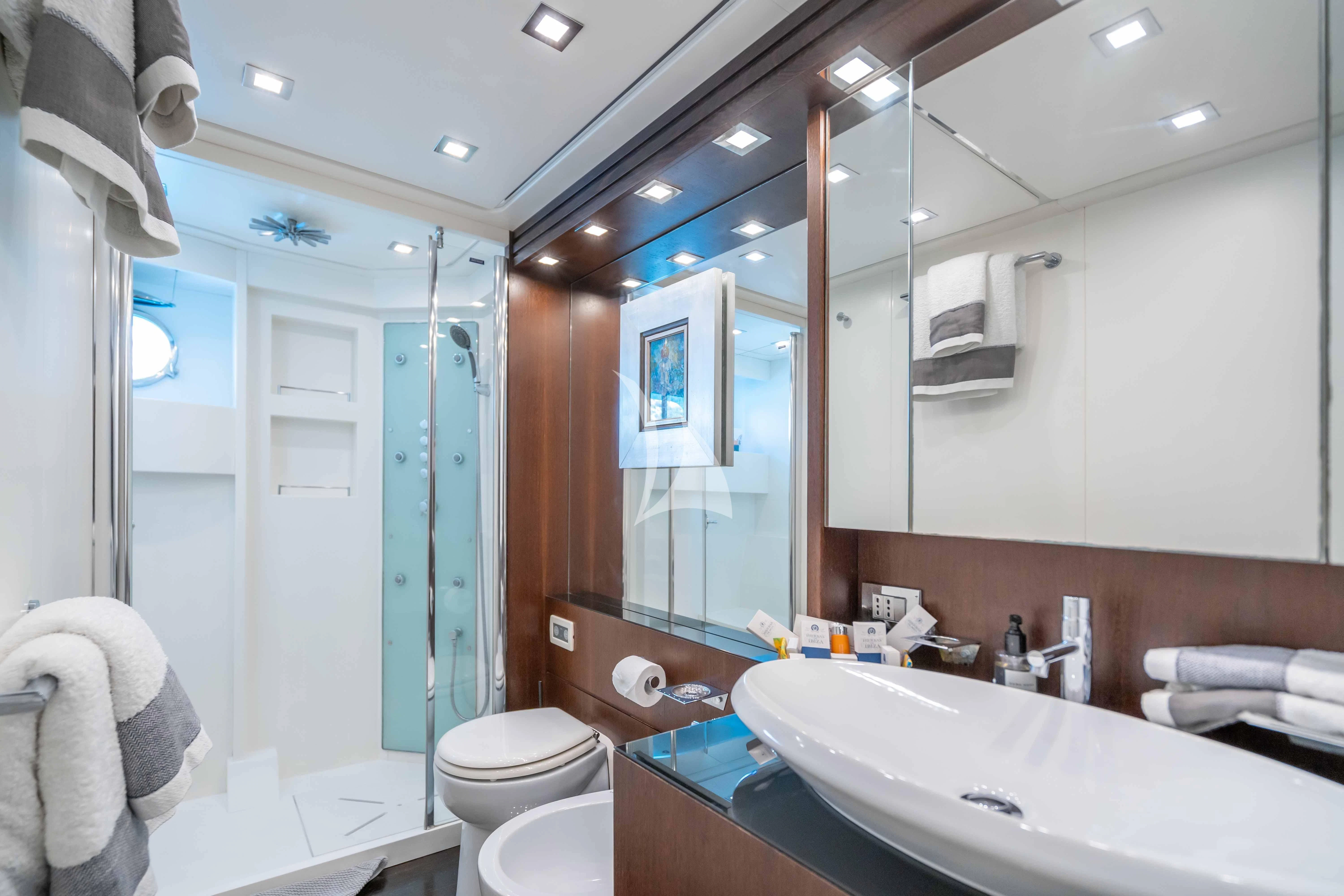 a bathroom with a large mirror aboard LEX Yacht for Sale