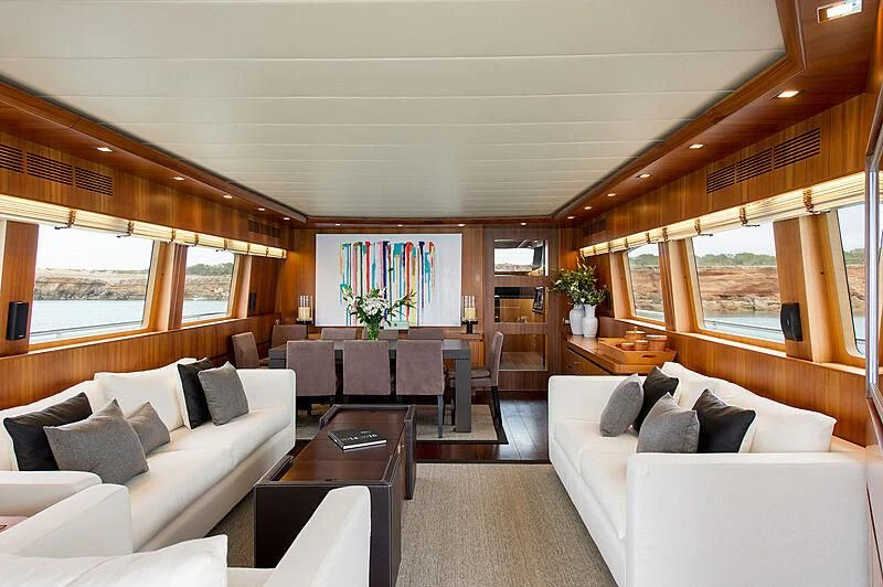 a living room with a large window aboard LEX Yacht for Sale