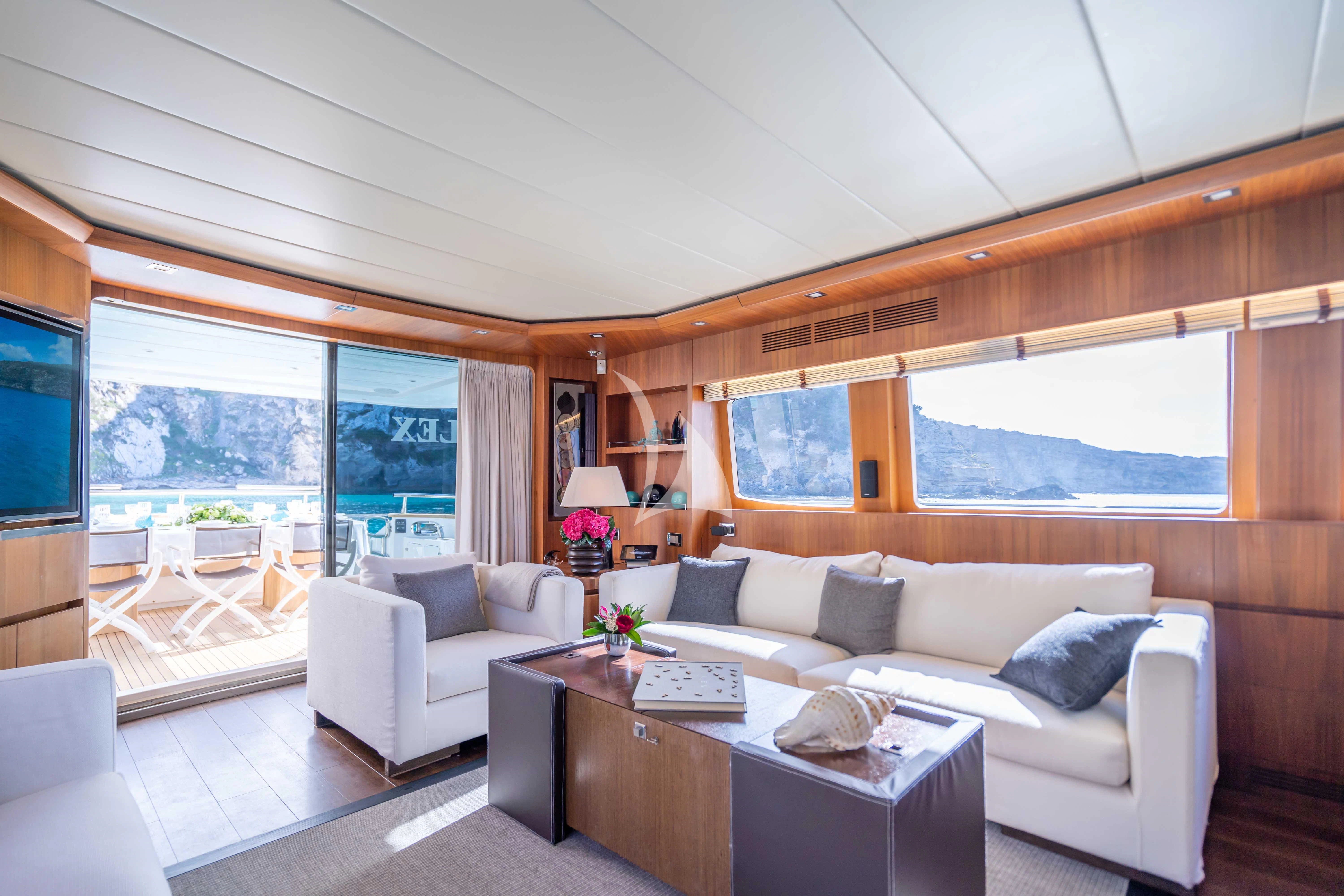 a living room with a couch and a table aboard LEX Yacht for Sale