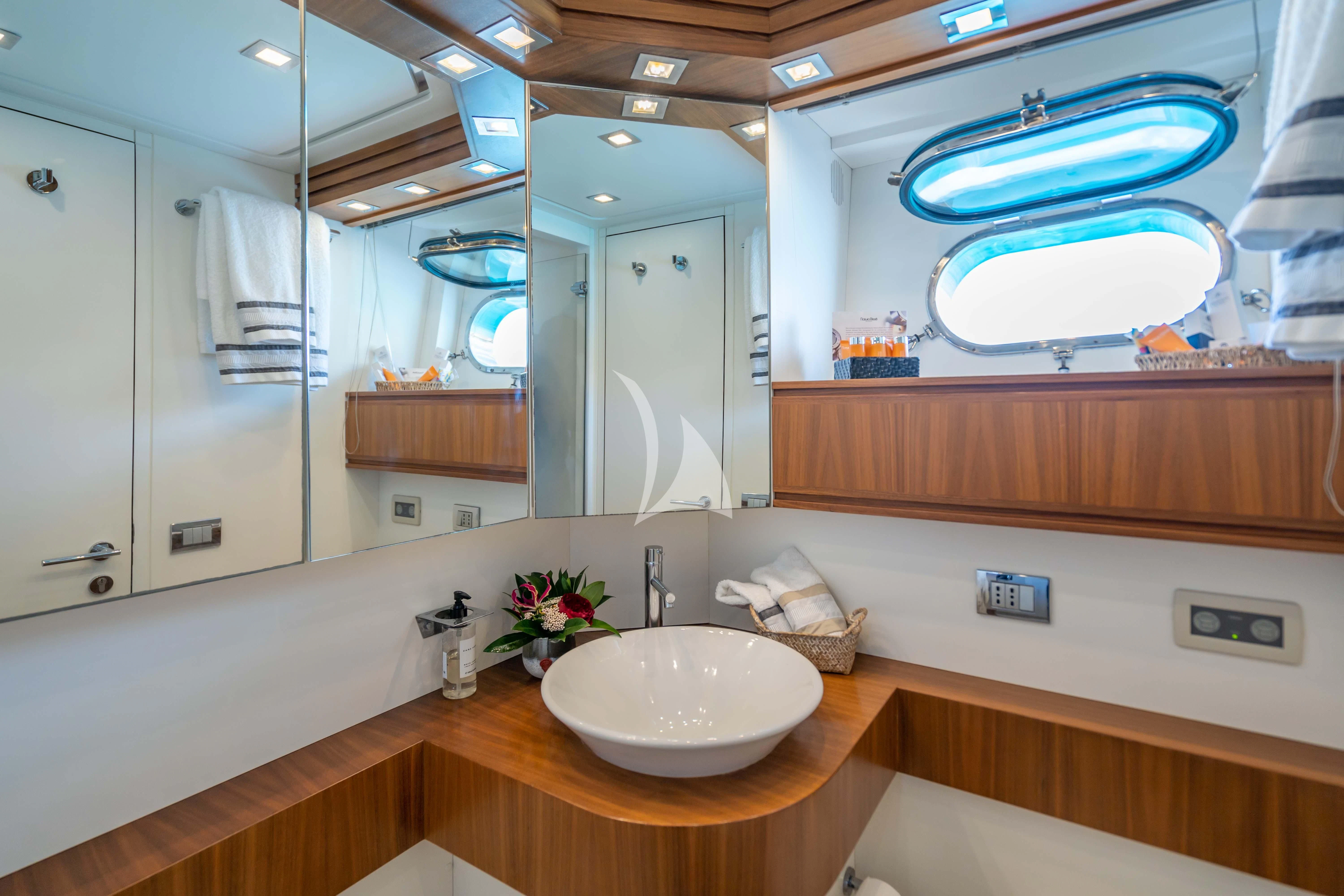 a bathroom with a large mirror aboard LEX Yacht for Sale