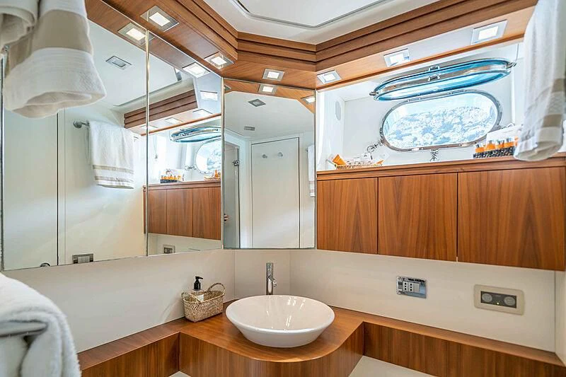 a bathroom with a sink and a mirror aboard LEX Yacht for Sale