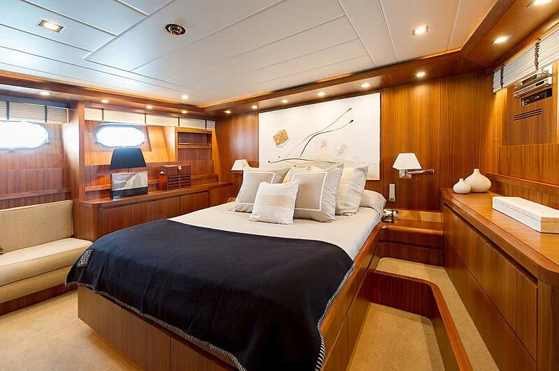 a room with a bed and a couch aboard LEX Yacht for Sale