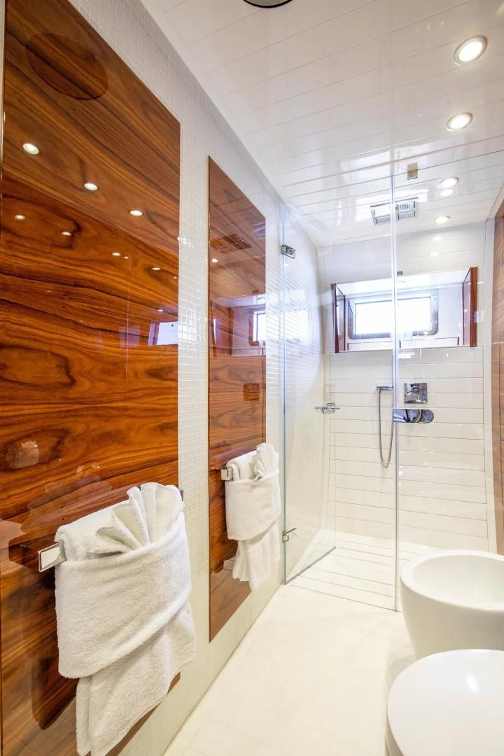 a bathroom with a glass shower aboard HATT MILL Yacht for Sale