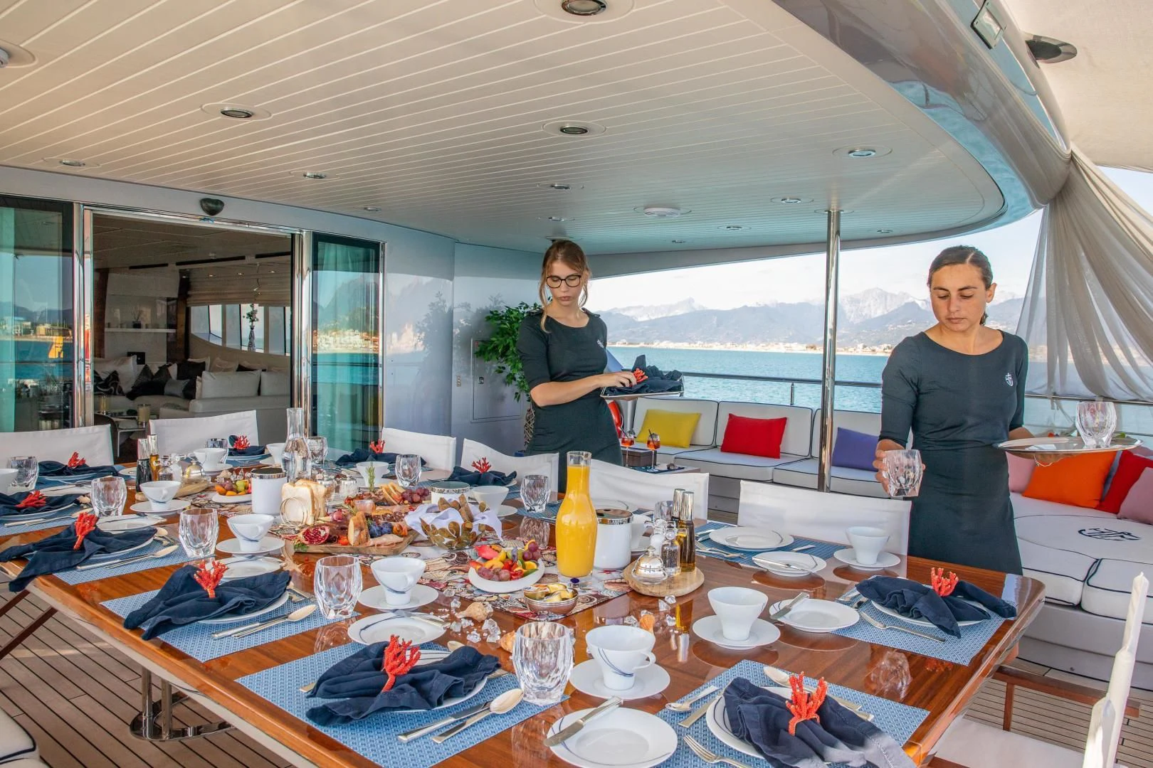 a couple of people standing by a table with food on it aboard HATT MILL Yacht for Sale