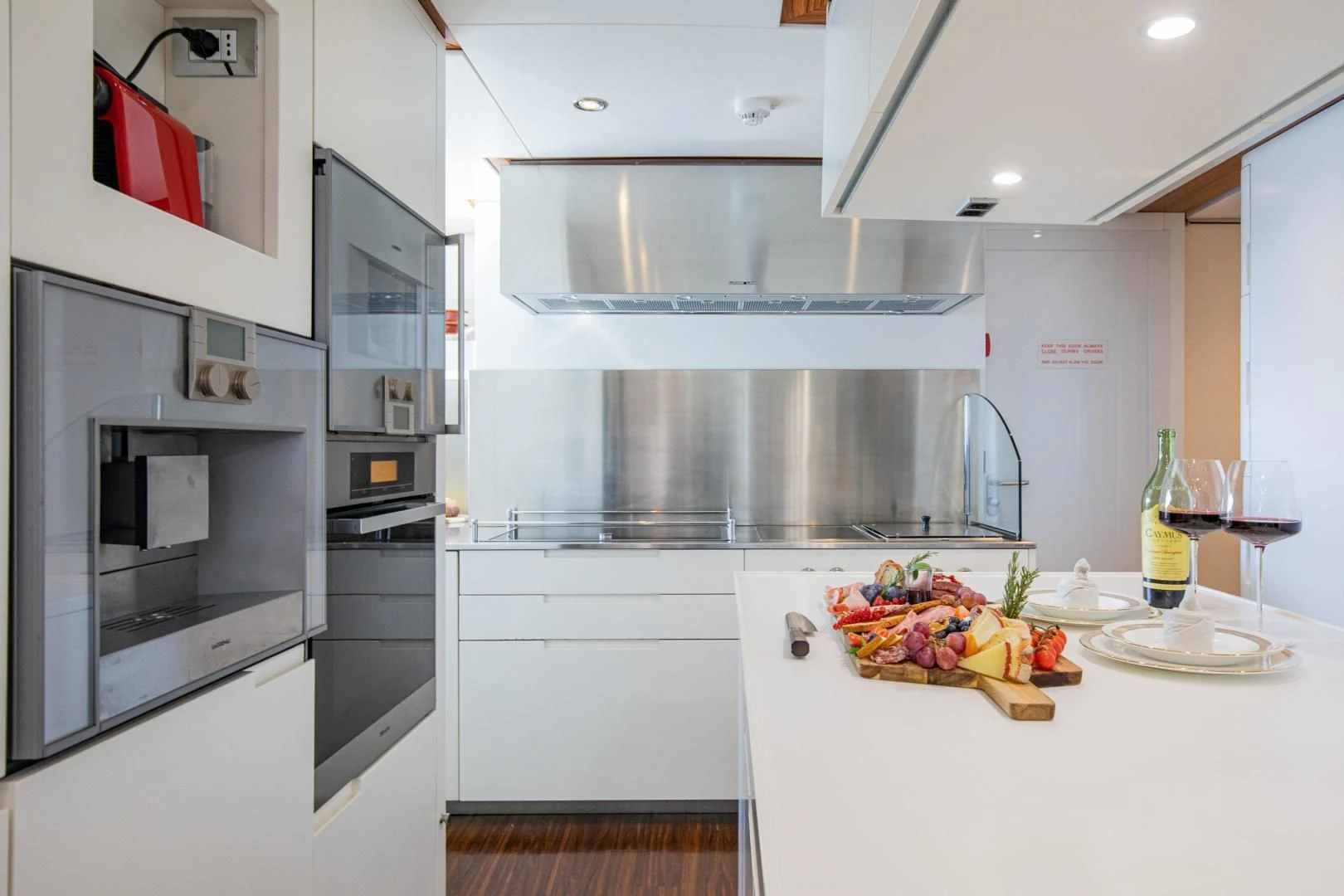 a kitchen with white cabinets aboard HATT MILL Yacht for Sale