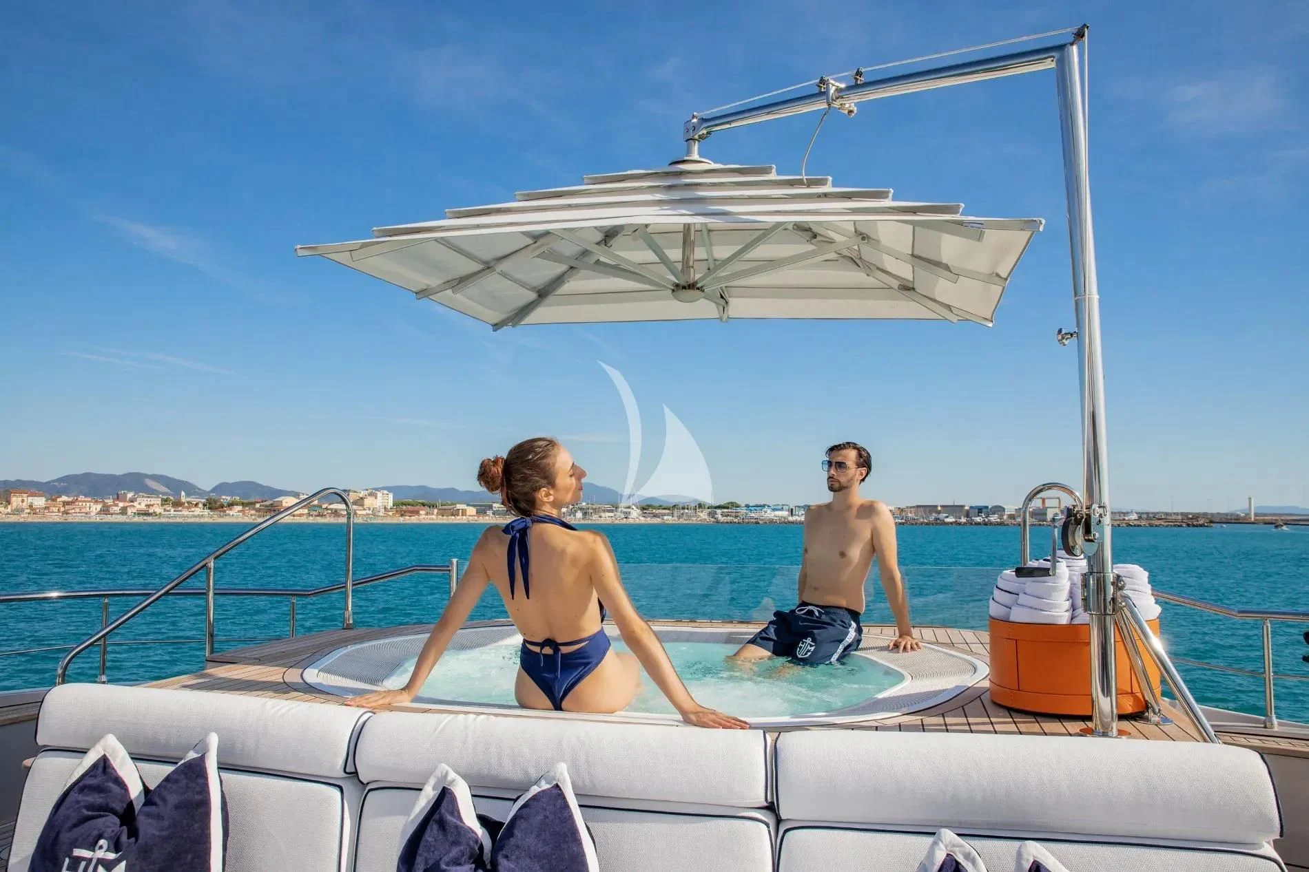 a man and woman sitting on a boat in the water aboard HATT MILL Yacht for Sale
