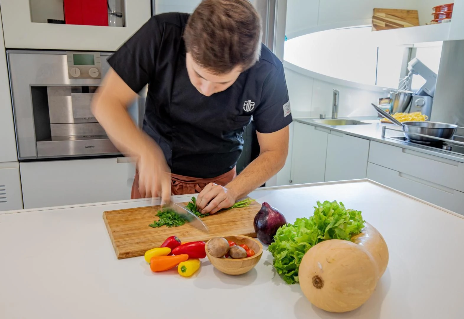 a person cutting vegetables on a cutting board aboard HATT MILL Yacht for Sale