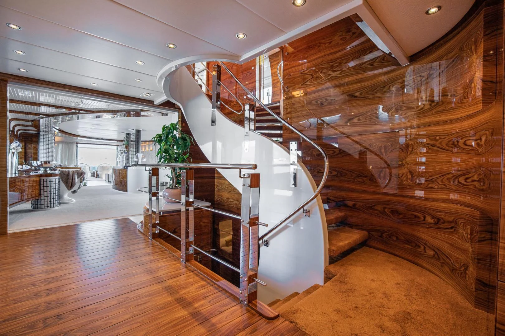 a large room with wooden stairs aboard HATT MILL Yacht for Sale