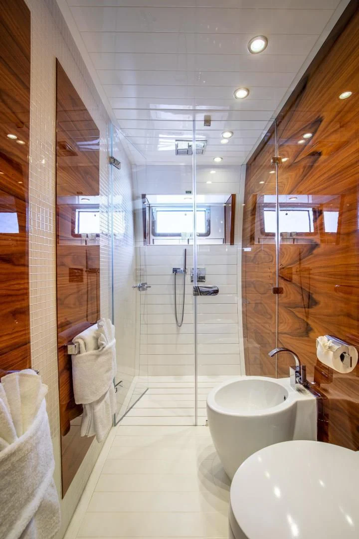a bathroom with a glass shower aboard HATT MILL Yacht for Sale