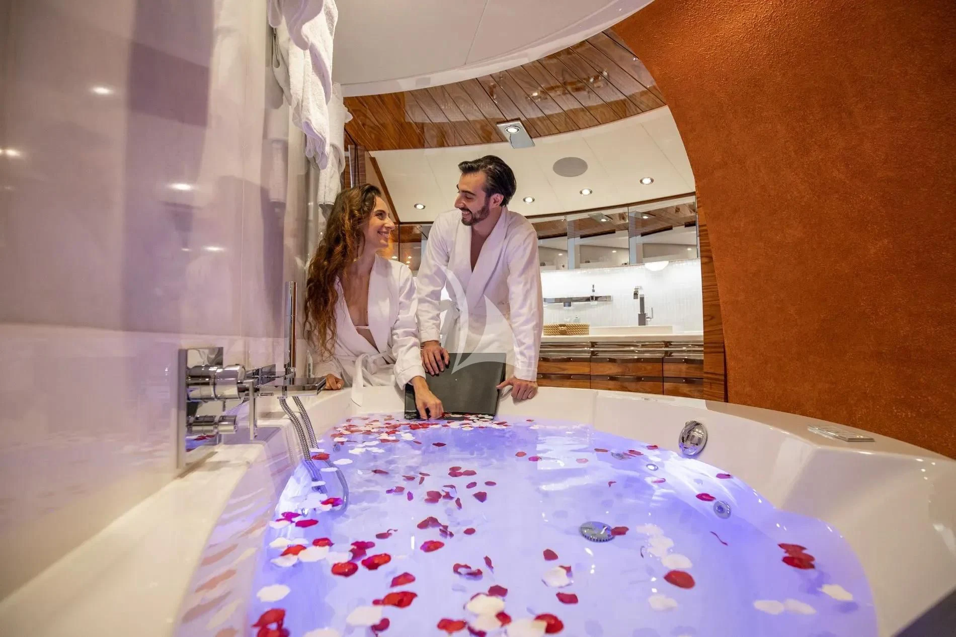 a man and woman standing next to a table with candies aboard HATT MILL Yacht for Sale