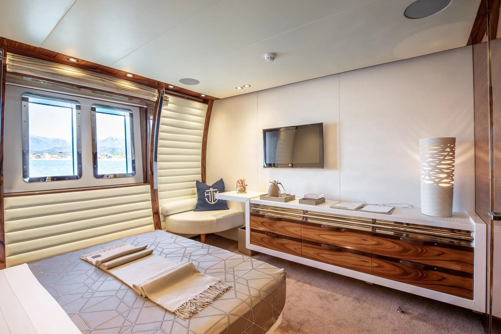 a bedroom with a bed and a desk aboard HATT MILL Yacht for Sale