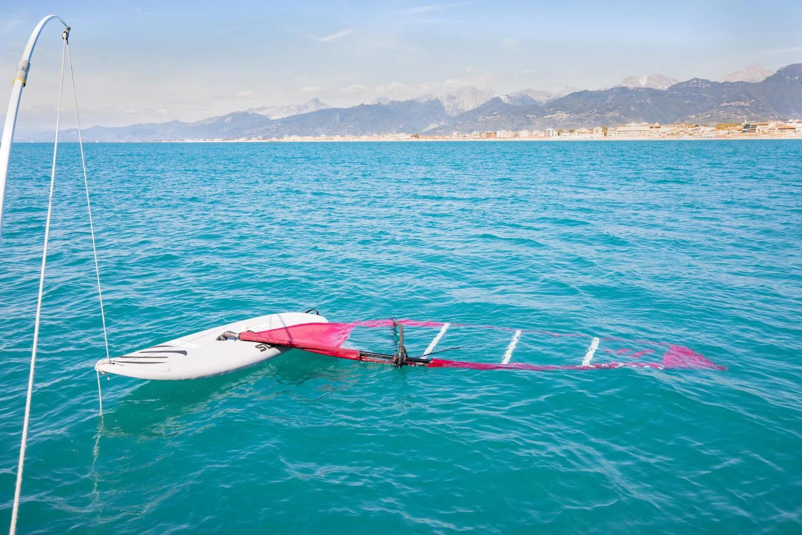 a pink and white sailboat in the ocean aboard HATT MILL Yacht for Sale