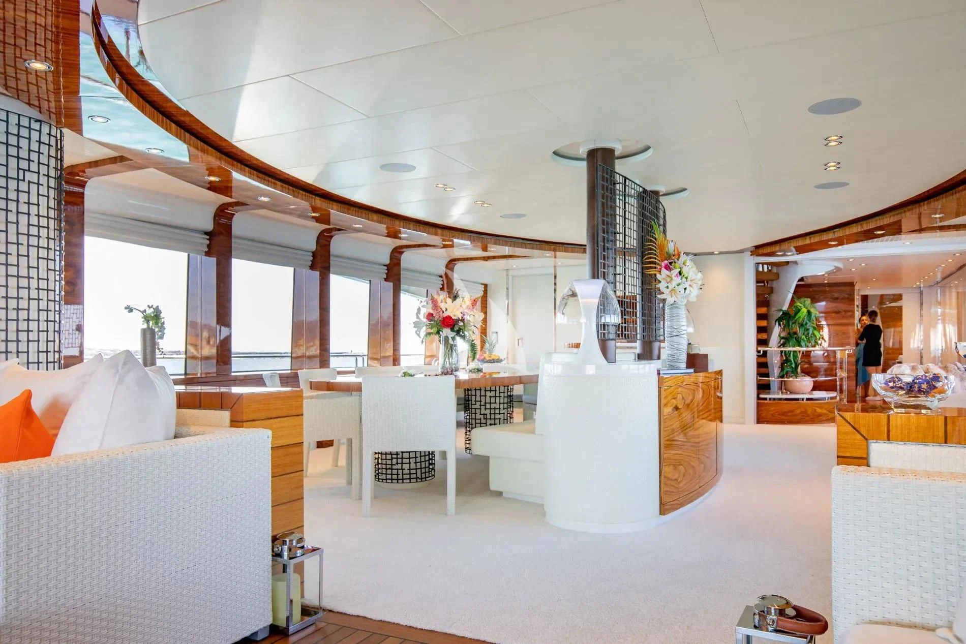 a room with a white table and chairs and a white table with flowers aboard HATT MILL Yacht for Sale