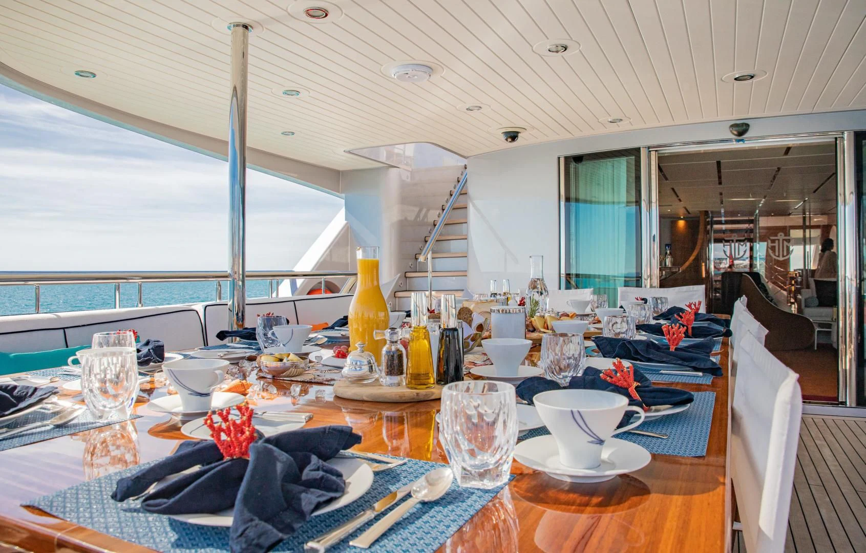 a dining table with a view of the ocean aboard HATT MILL Yacht for Sale