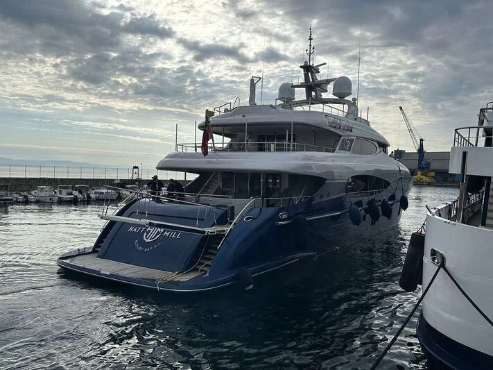 a large white boat in a harbor aboard HATT MILL Yacht for Sale