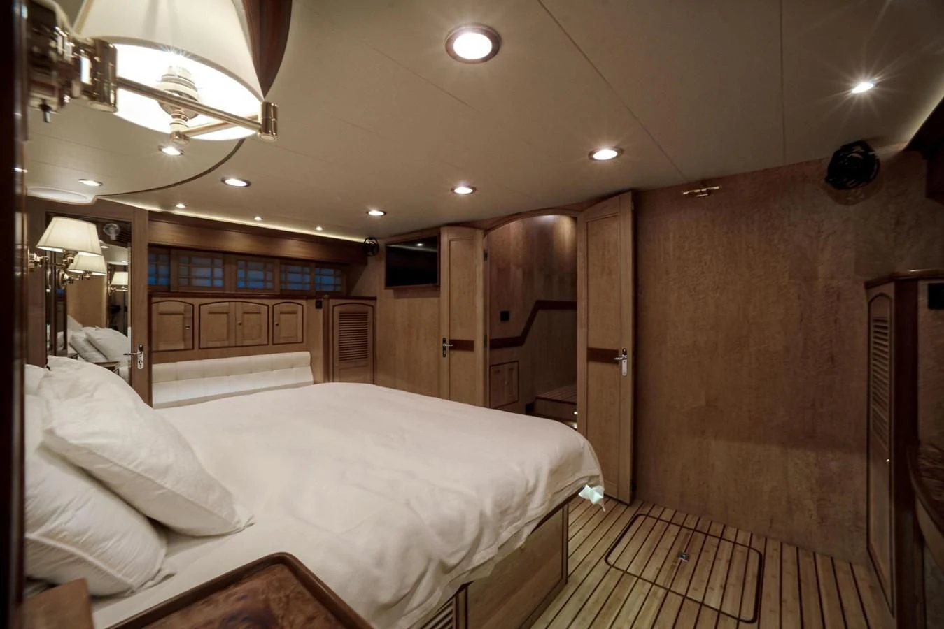 a room with a bed and a wood wall aboard BEN'S BARGE Yacht for Sale