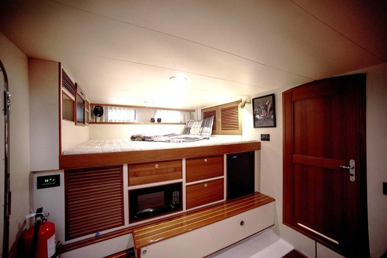 a kitchen with wooden cabinets aboard BEN'S BARGE Yacht for Sale