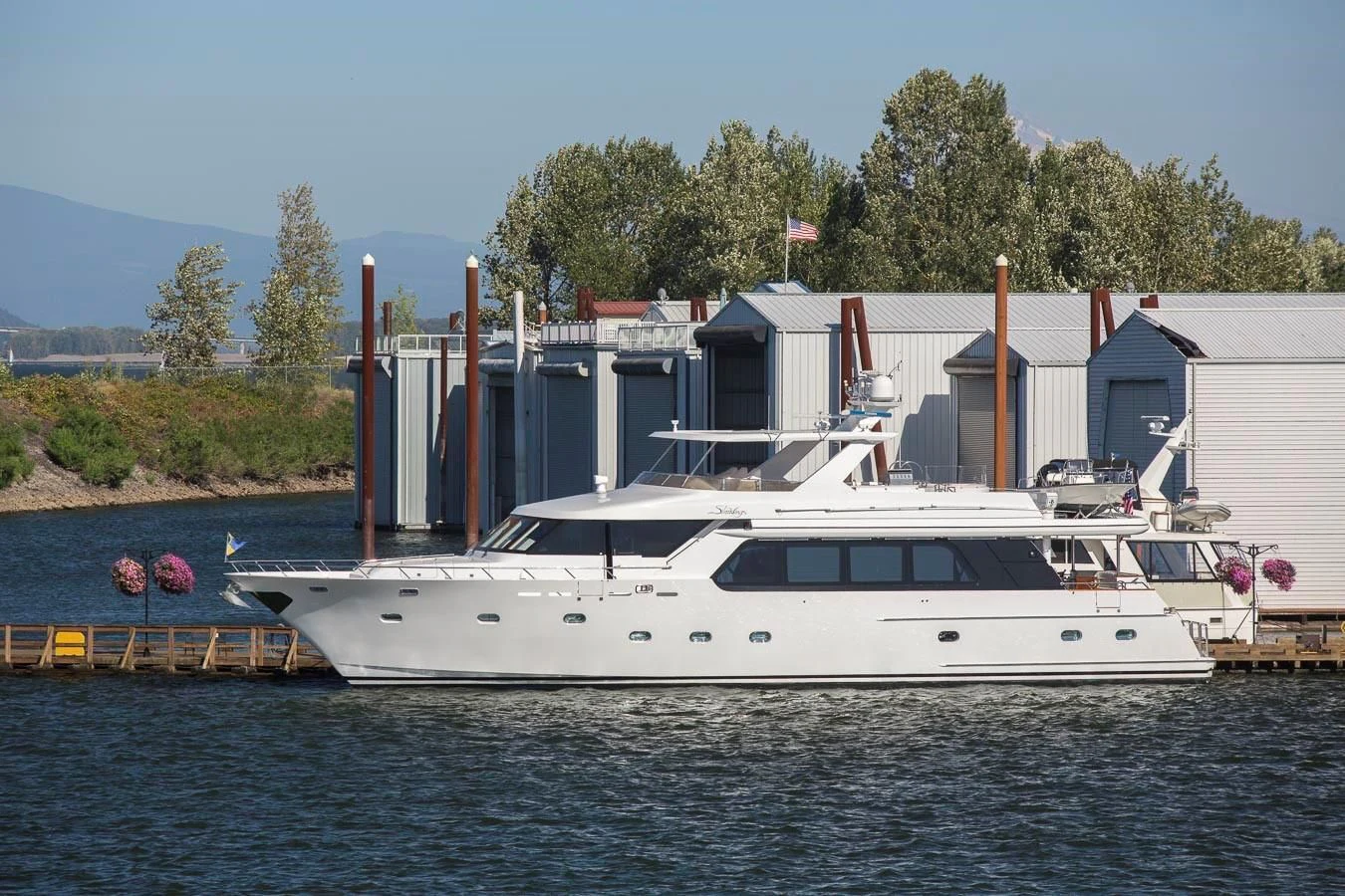 a large white boat in a harbor aboard SILVER WINGS Yacht for Sale