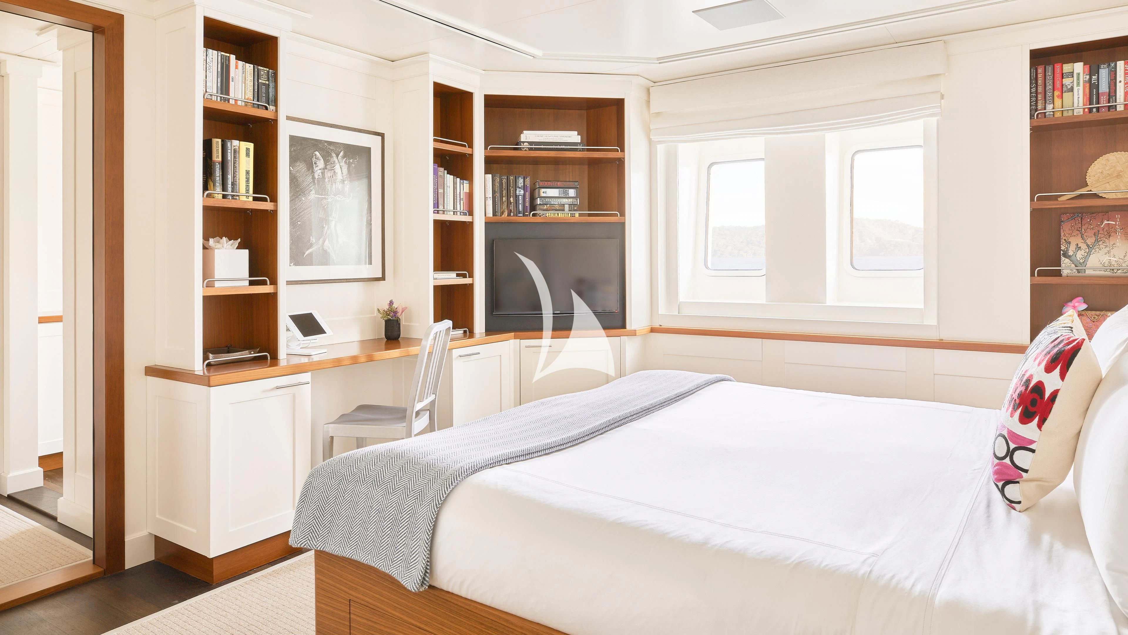 a bedroom with a bed and a bookcase aboard SENSES Yacht for Sale
