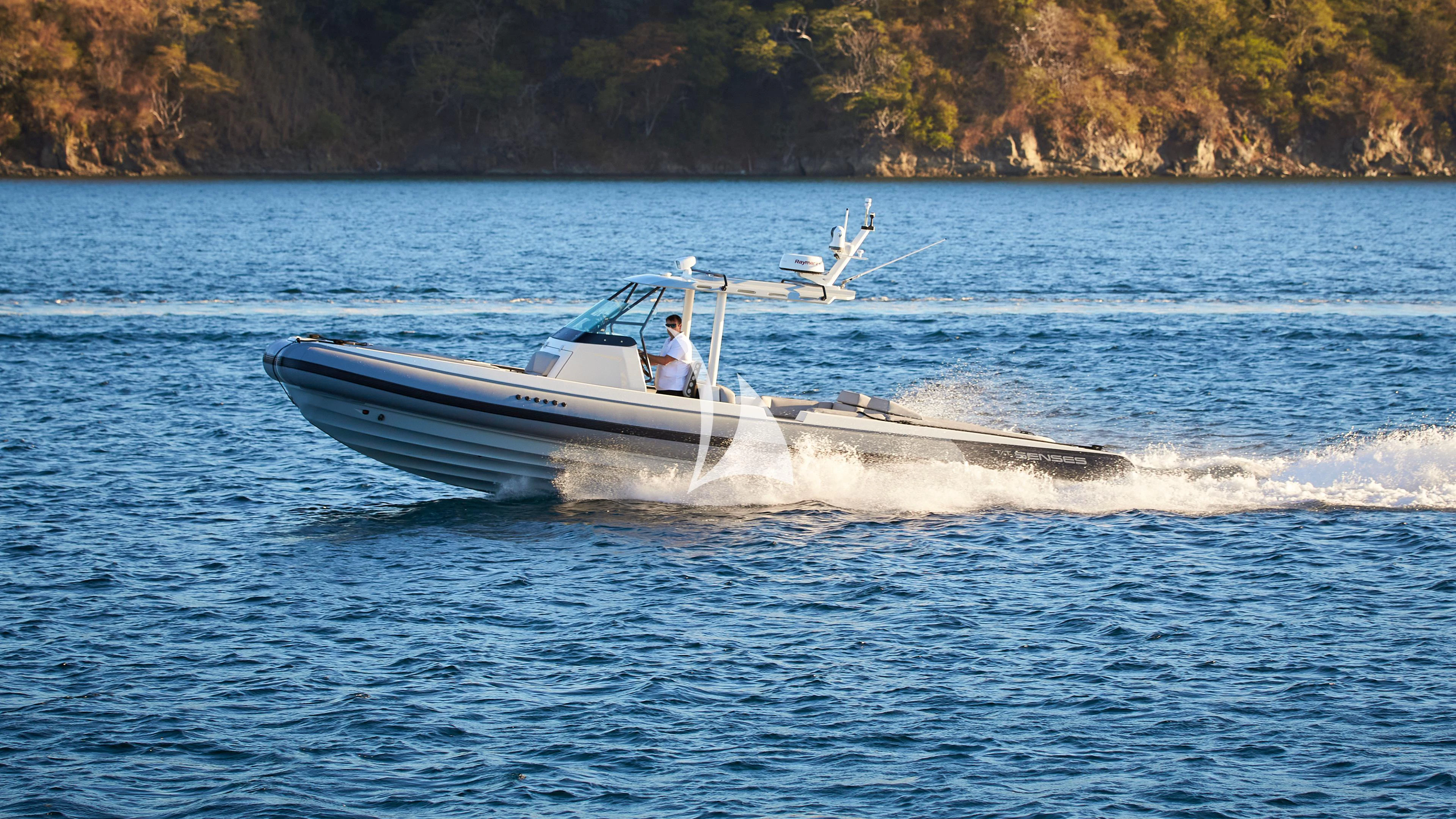 a person driving a boat on the water aboard SENSES Yacht for Sale