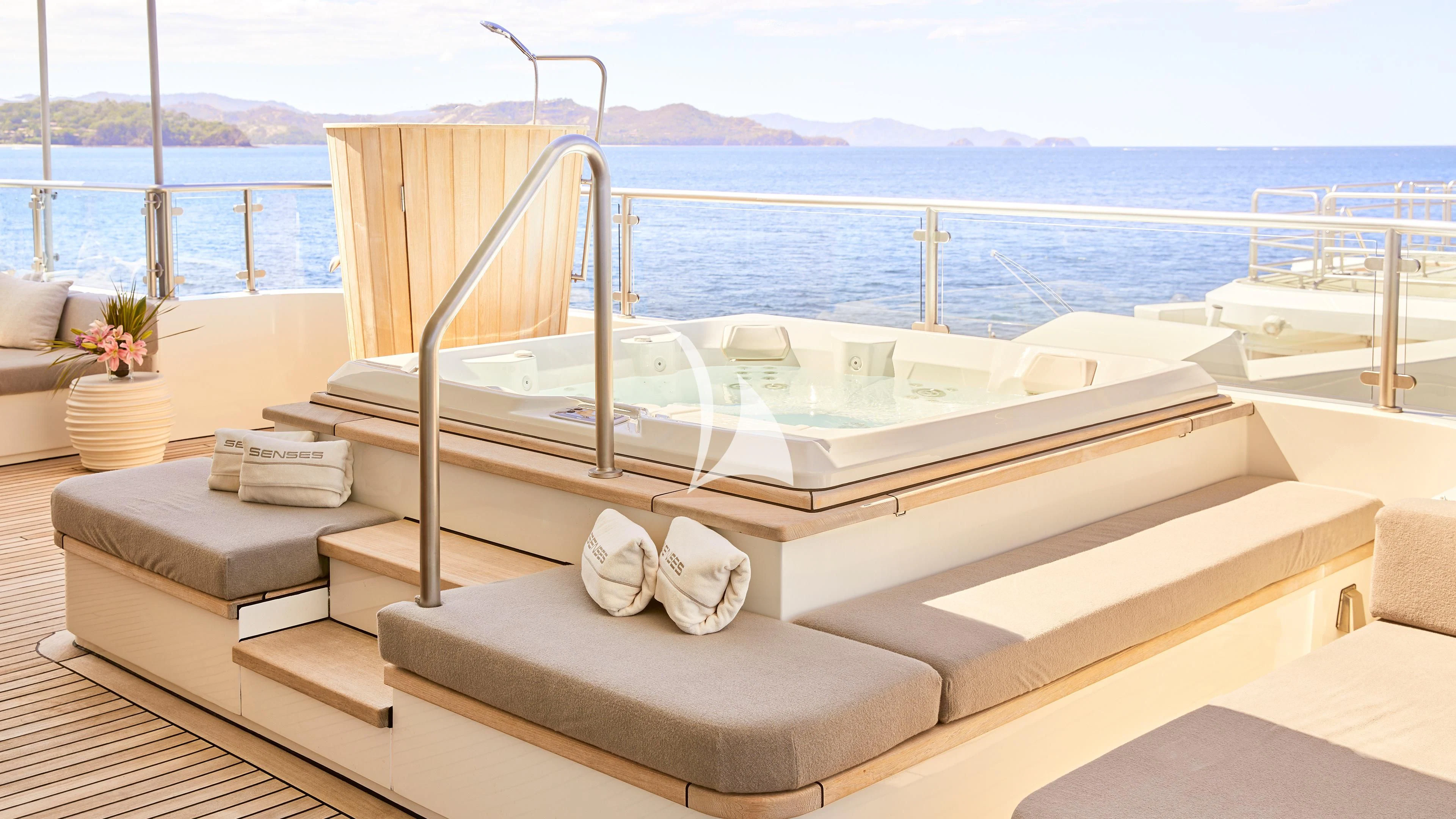 a white bed on a balcony aboard SENSES Yacht for Sale