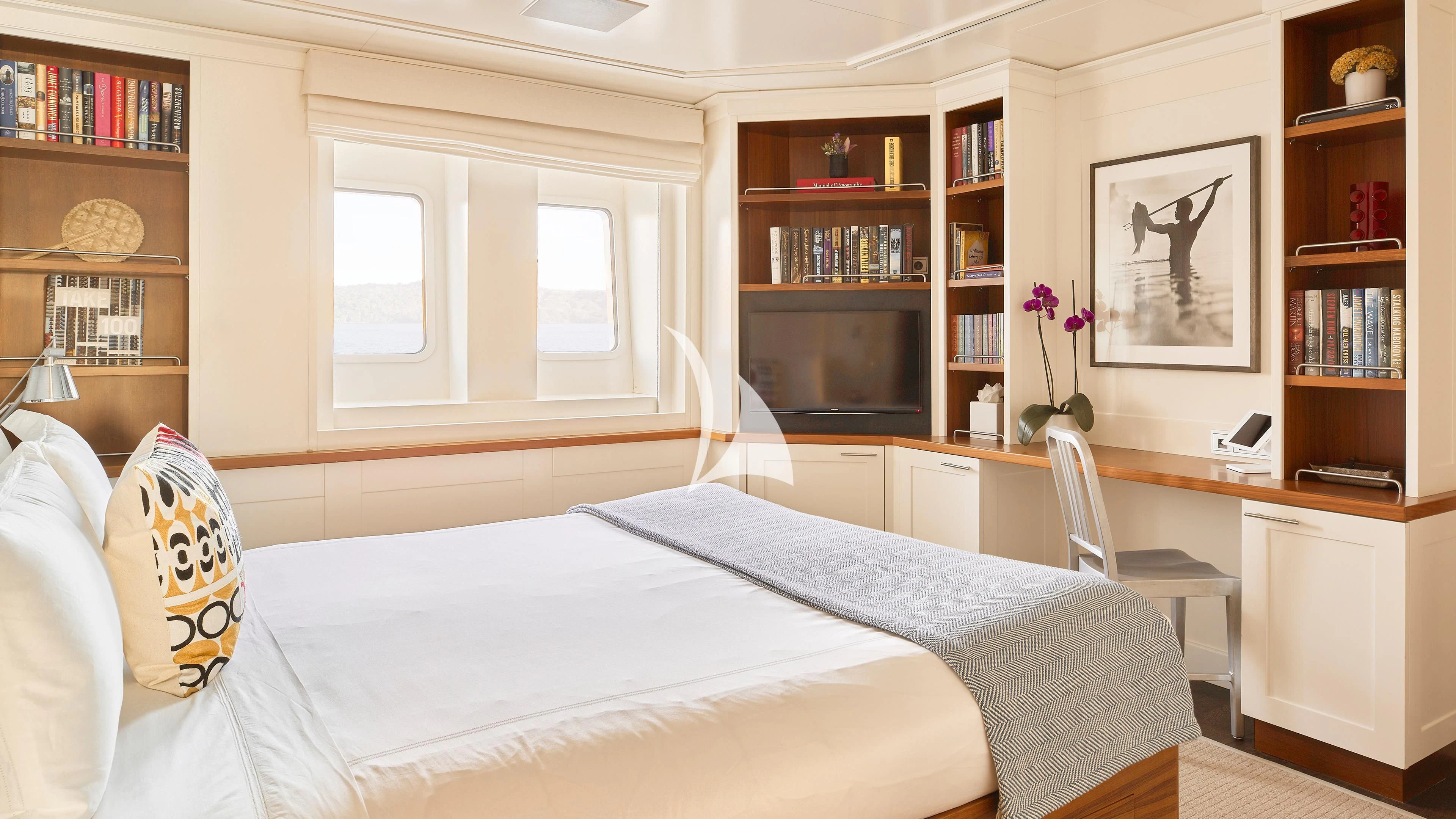 a bedroom with a bed and a desk aboard SENSES Yacht for Sale