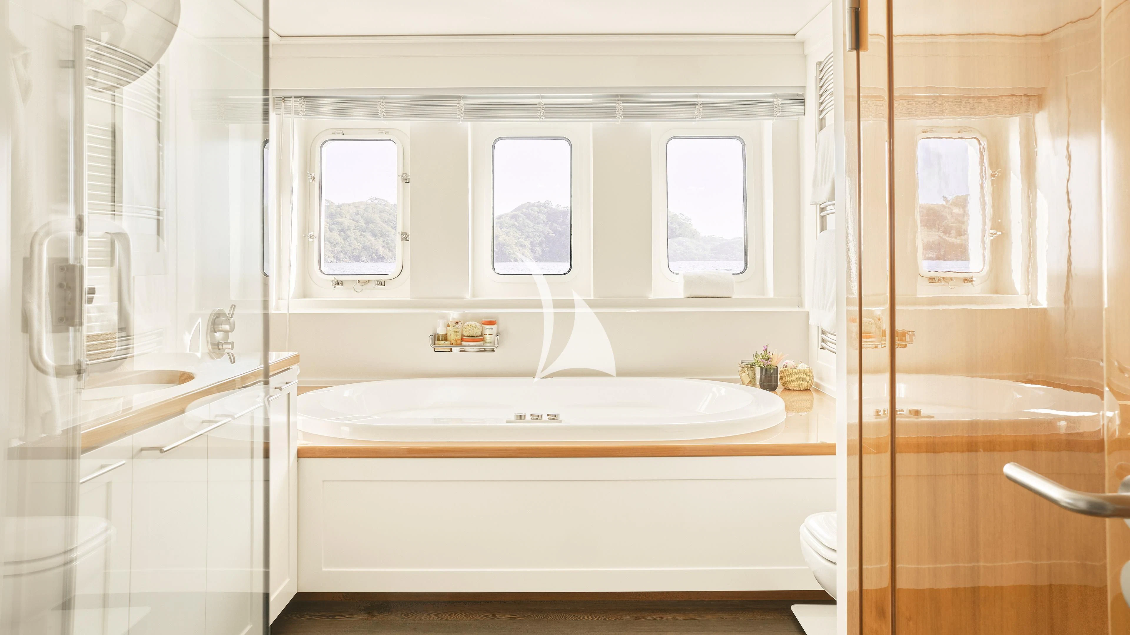 a bathroom with a tub sink and cabinets aboard SENSES Yacht for Sale