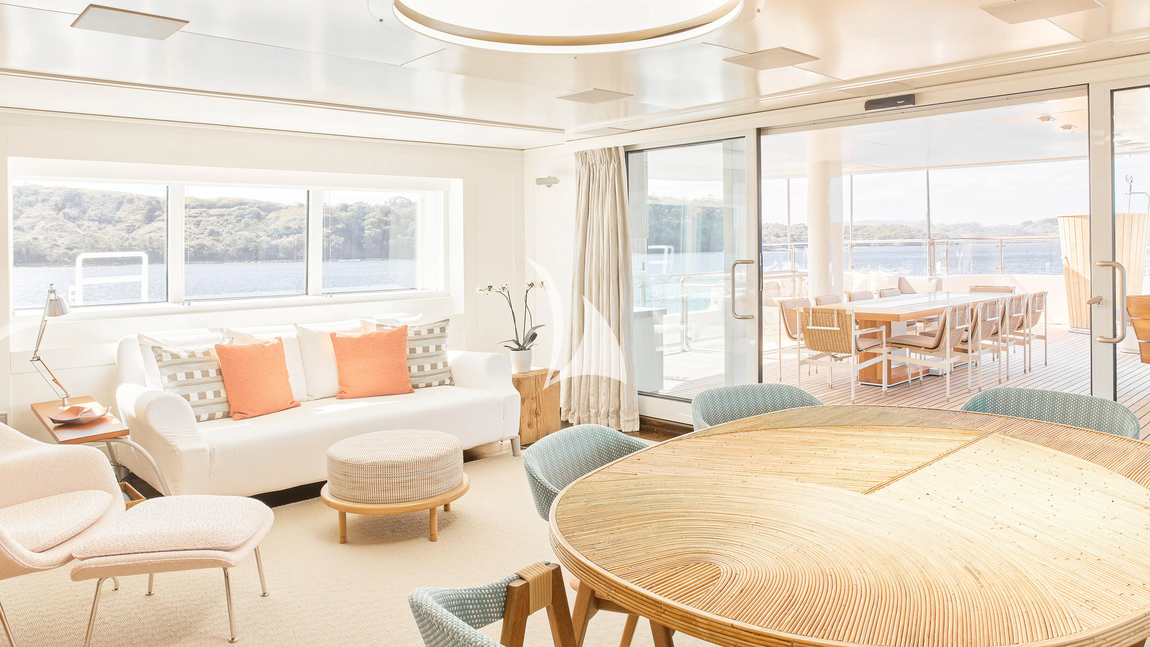 a room with a bed and a table and chairs aboard SENSES Yacht for Sale